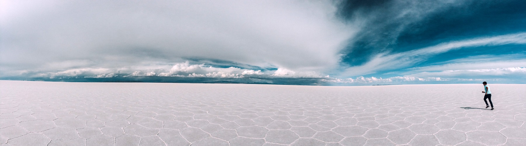 Vast white salt flats beneath a dramatic sky in Bolivia