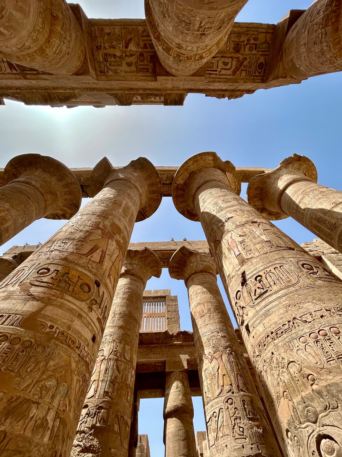 Carved stone columns reaching towards the sky at Karnak Temple