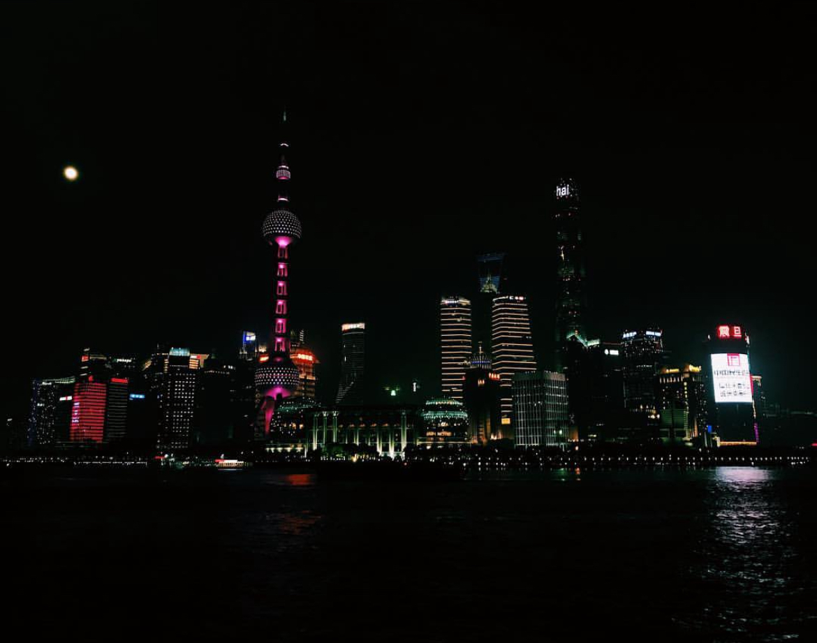 Shanghai's illuminated Pudong skyline reflected across the river at night